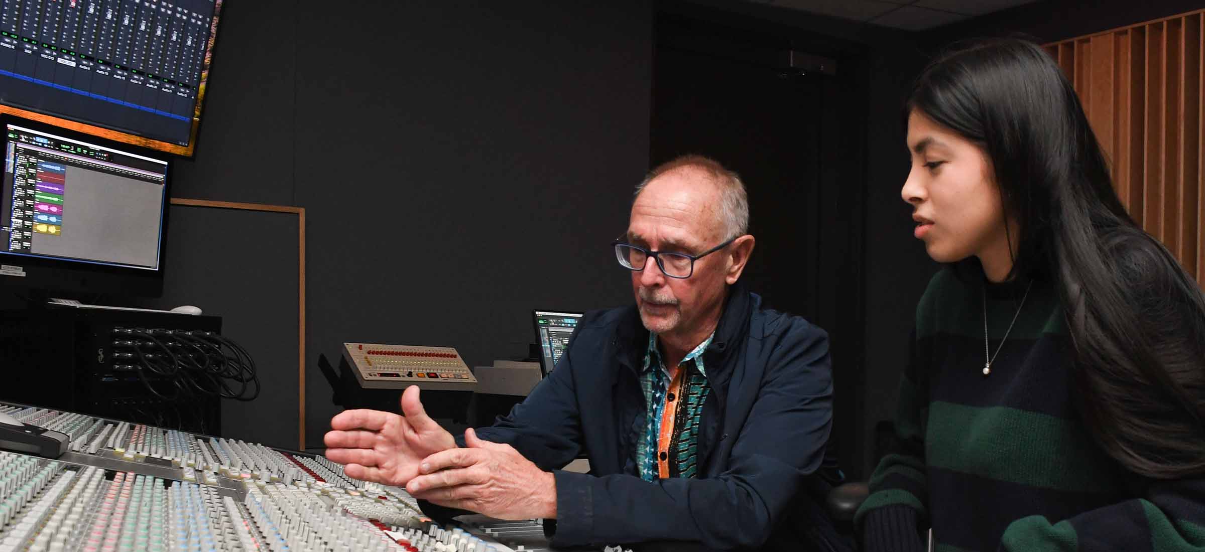 Audio Engineering instructor and student working control board