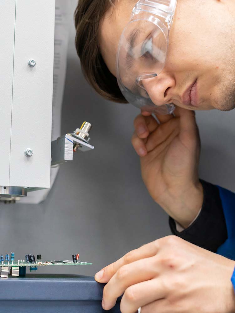Man studying computer board.