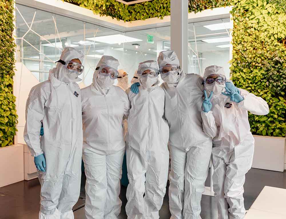 Students practice proper gowning during a BioPath @ TMC learning experience.