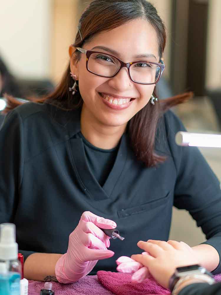 female cosmetology student doing nails