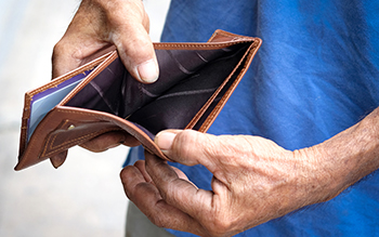 Man opening wallet that is empty inside